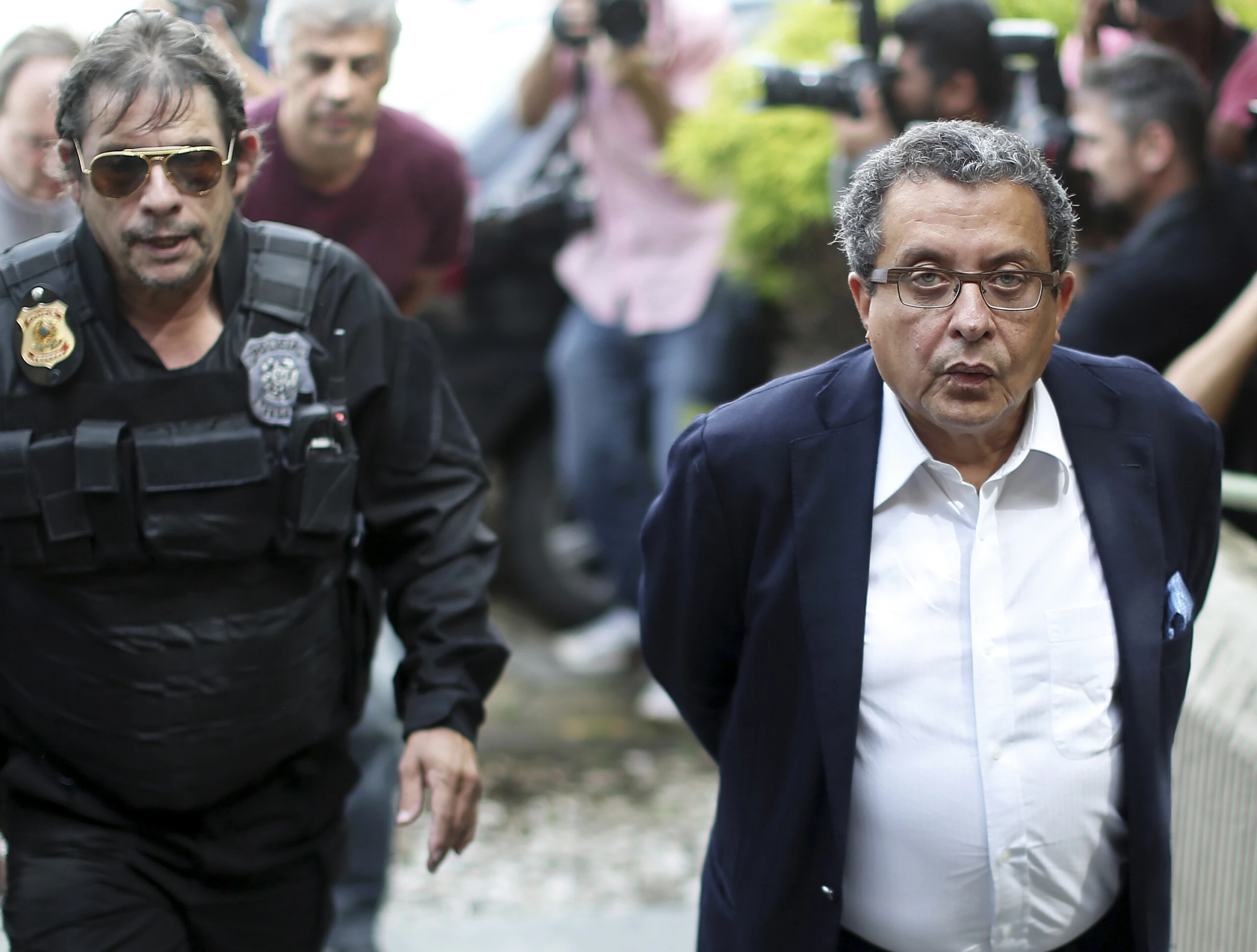 Brazilian President Dilma Rousseff and former Brazilian President (2003-2011) Luiz Inacio Lula Da Silva's campaign publicist Joao Santana (R) is arrested upon his arrival in Sao Paulo, Brazil o February 23, 2016. Political consultant Santana was being investigated by the Brazilian justice for receiving payments outside the country which could come from Brazilian state-run oil company Petrobras' briberies. AFP PHOTO / STR / AFP / STR        (Photo credit should read STR/AFP/Getty Images)