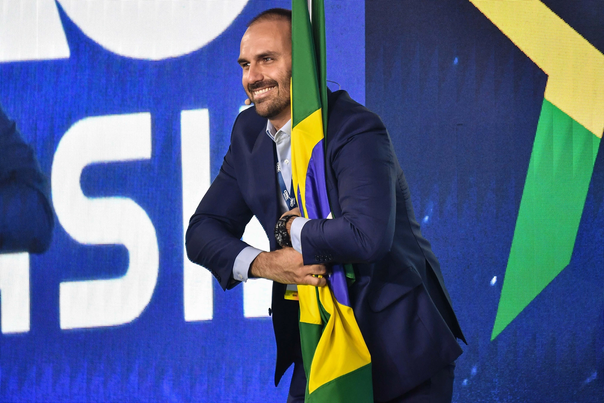 Brazilian Deputy Eduardo Bolsonaro, son of Brazilian President Jair Bolsonaro, holds a Brazilian national flag during the Conservative Political Action Conference (CPAC), in Sao Paulo, Brazil, on October 11, 2019. (Photo by NELSON ALMEIDA / AFP) (Photo by NELSON ALMEIDA/AFP via Getty Images)