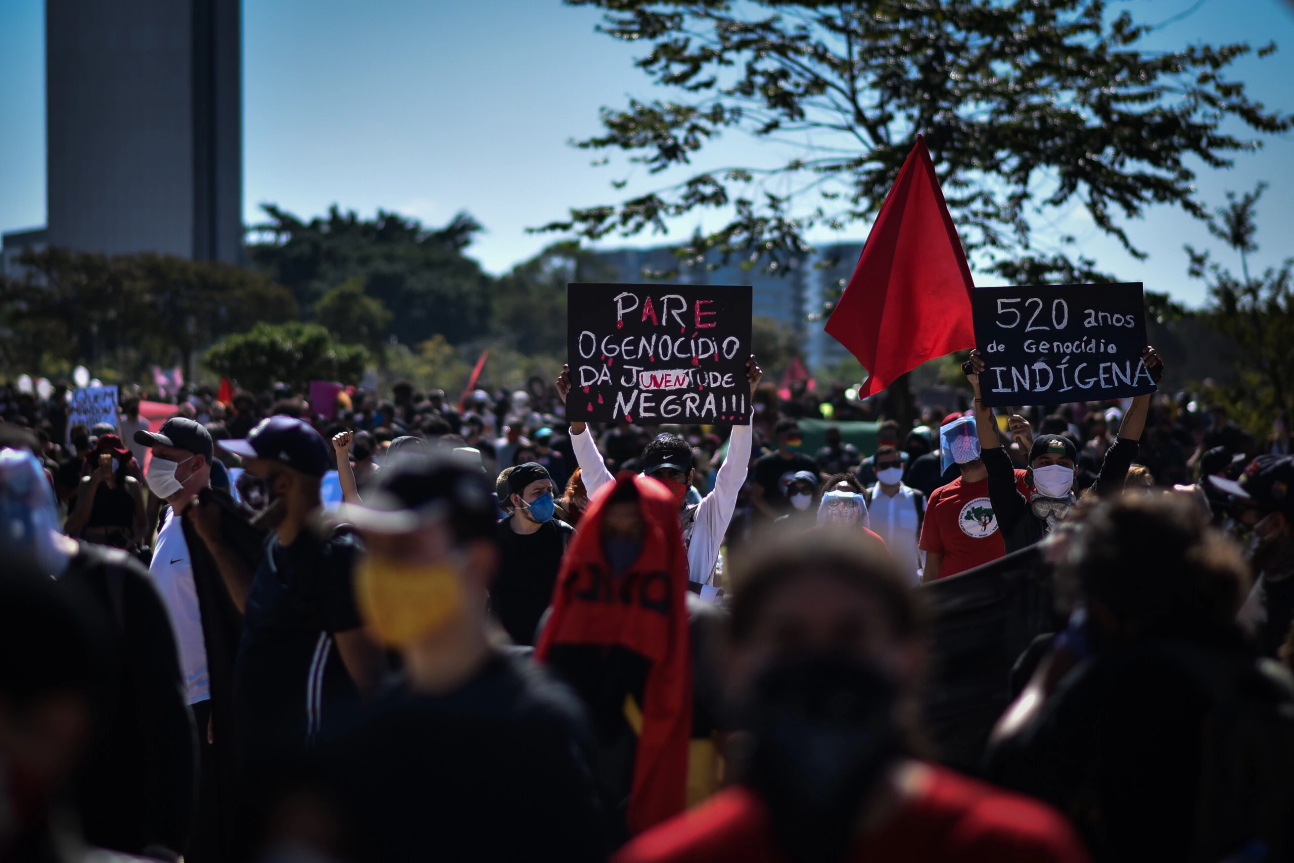 A demonstrator holds a banner that reads in Portuguese stop the genocice of black youth during a  anti-fascist protest against racism, President Jair Bolsonaros government, and to defend democracy amid the Coronavirus pandemic (COVID-19), in Brasilia, Brazil, Sunday, June 7, 2020. (Photo by Andre Borges/NurPhoto via Getty Images)