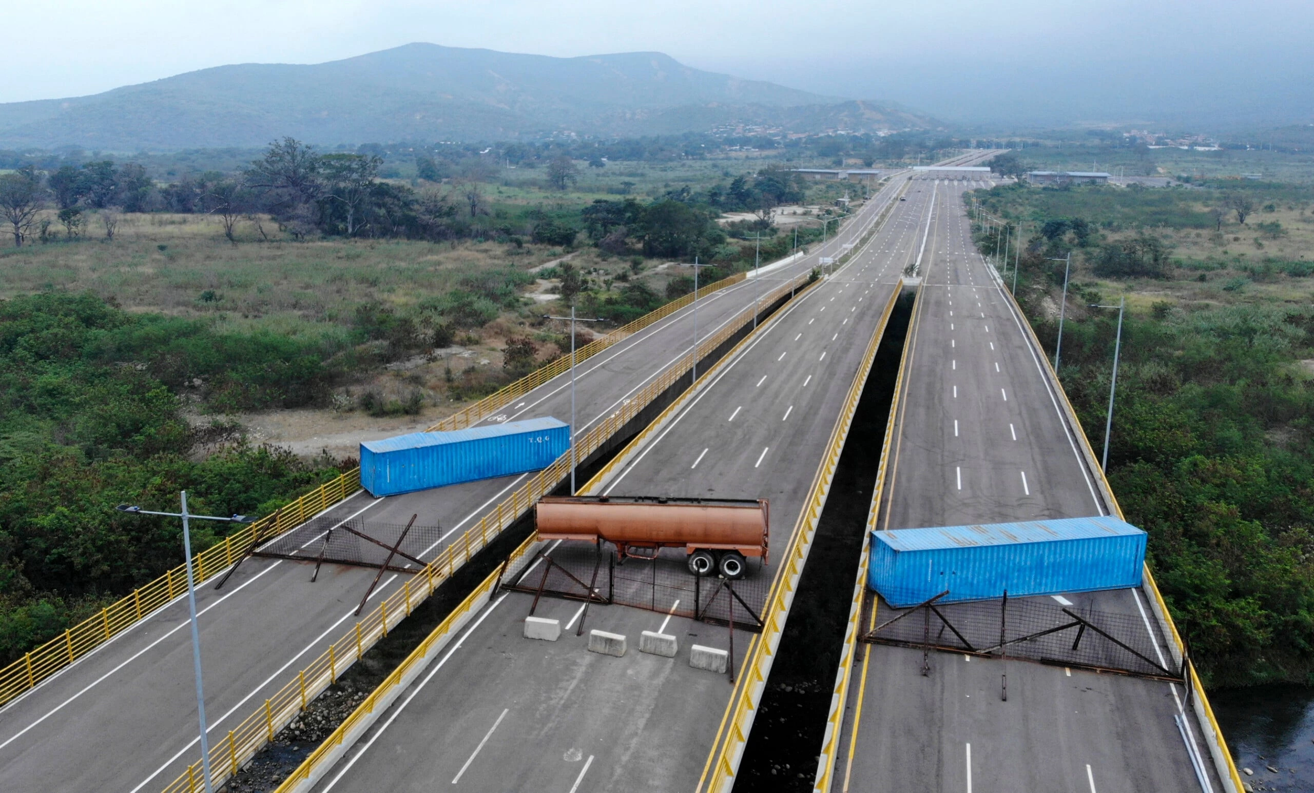 Aerial view of the Tienditas Bridge, in the border between Cucuta, Colombia and Tachira, Venezuela, after Venezuelan military forces blocked it with containers on February 6, 2019. - Venezuelan military officers blocked a bridge on the border with Colombia ahead of an anticipated humanitarian aid shipment, as opposition leader Juan Guaido stepped up his challenge to President Nicolas Maduro's authority. (Photo by EDINSON ESTUPINAN / AFP)        (Photo credit should read EDINSON ESTUPINAN/AFP/Getty Images)