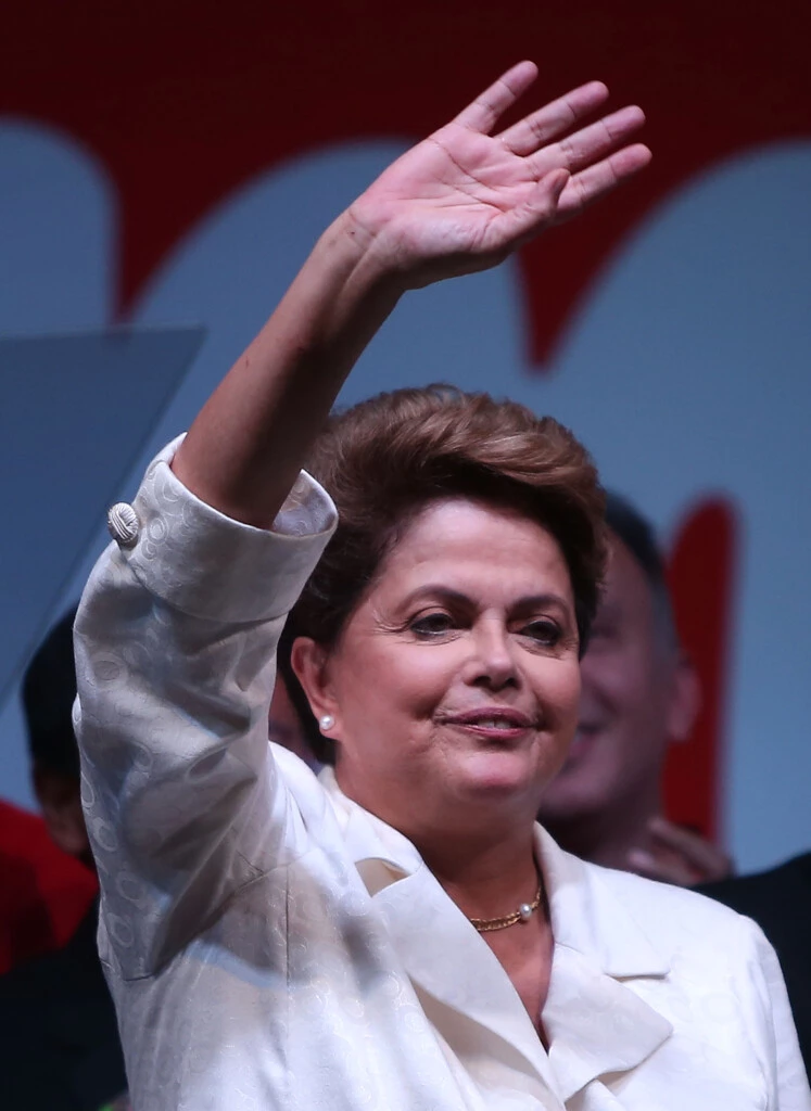 BRASILIA, BRAZIL - OCTOBER 26: Brazilian President and Workers' Party (PT) candidate Dilma Rousseff (C) celebrates with Brazil's former president Luiz Inacio Lula Da Silva (R) after being re-elected on October 26, 2014 in Brasilia, Brazil. Rousseff defated Presidential candidate of the Brazilian Social Democratic Party (PSDB) Aecio Neves in a run-off election. (Photo by Mario Tama/Getty Images)