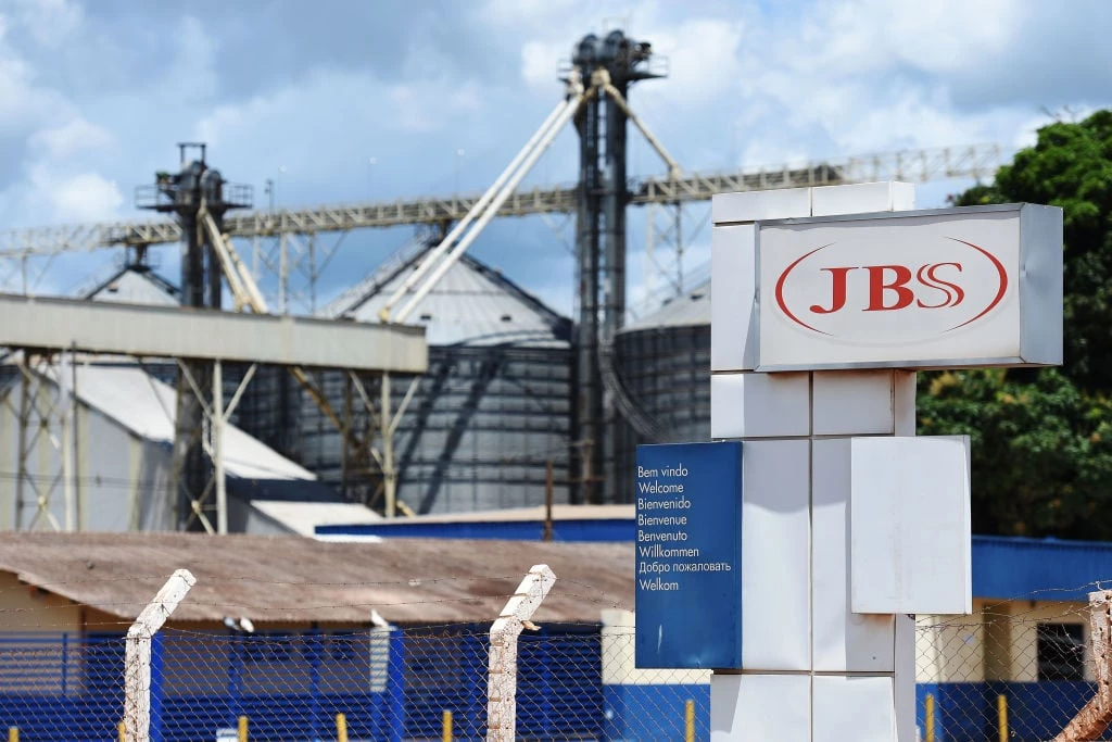 View of the JBS-Friboi Logo at the chicken processing plant entrance, in Samambaia, Federal District, Brazil on March 17, 2017.<br /> Brazilian Federal police have dismantled, after two years of running the "weak flesh" operation, a vast network of adulterated food, involving major meat processing plants and inspectors who accepted bribes to approve products in bad condition for domestic consumption and exportation. / AFP PHOTO / EVARISTO SA (Photo credit should read EVARISTO SA/AFP/Getty Images)