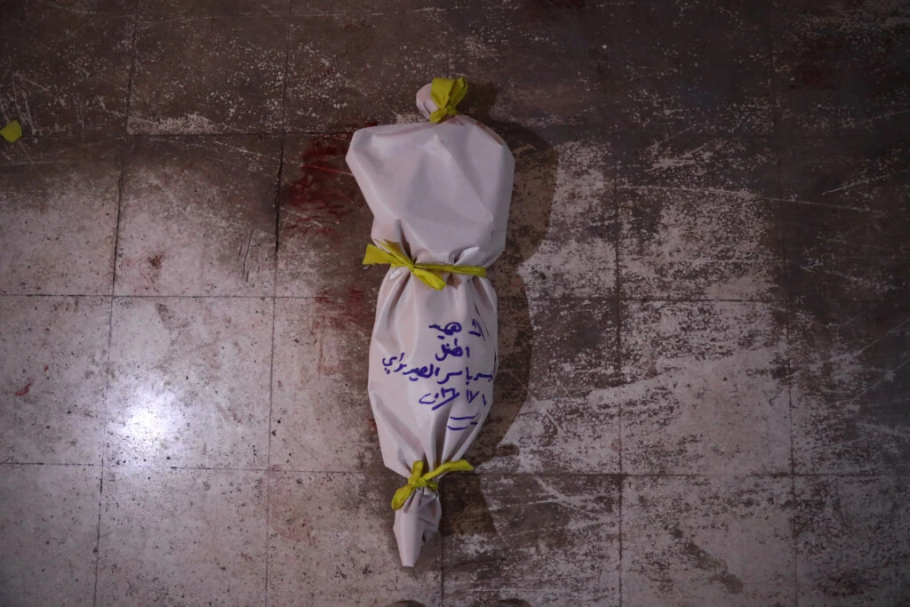 TOPSHOT - The body of a victim lies on the floor at a make-shift morgue following an airstrike in the rebel-held town of Douma, on the eastern outskirts of the capital Damascus, on November 10, 2016.At least 11 people including four children were killed on November 10 in air strikes on rebel-held areas near the Syrian capital, with one strike on the besieged town of Douma killing eight people including three children, according to the Syrian Observatory for Human Rights. / AFP / Abd Doumany (Photo credit should read ABD DOUMANY/AFP/Getty Images)