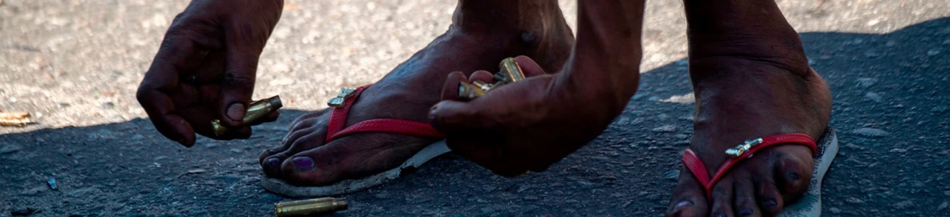 A resident of the Complex do Alemao favela collects cases on Itaoca Avenue as Rio de Janeiro’s Military Police Special Unit (Choque) carries out an operation at the slum, in Rio, Brazil, on July 16, 2018. A resident of the Complex do Alemao favela collects cases on Itaoca Avenue as Rio de Janeiro’s Military Police Special Unit (Choque) carries out an operation at the slum, in Rio, Brazil, on July 16, 2018.