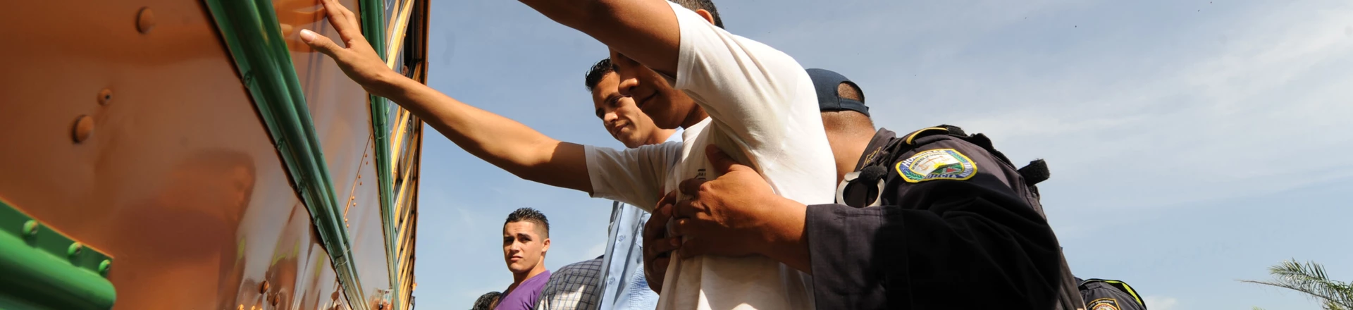 Policemen frisk the passengers of a bus near Tocoa, 600 km northeast of Tegucigalpa on August 2, 2012. Honduran police conducts a weapons search operation in the vicinity of Tocoa, after the Congress on Wednesday night banned carrying weapons in the Colon department, in an attempt to stop the clashes between farmers and landownwers which have left a toll of 78 deaths in three years. AFP PHOTO/ Orlando SIERRA (Photo credit should read ORLANDO SIERRA/AFP/GettyImages) Policemen frisk the passengers of a bus near Tocoa, 600 km northeast of Tegucigalpa on August 2, 2012. Honduran police conducts a weapons search operation in the vicinity of Tocoa, after the Congress on Wednesday night banned carrying weapons in the Colon department, in an attempt to stop the clashes between farmers and landownwers which have left a toll of 78 deaths in three years. AFP PHOTO/ Orlando SIERRA (Photo credit should read ORLANDO SIERRA/AFP/GettyImages)
