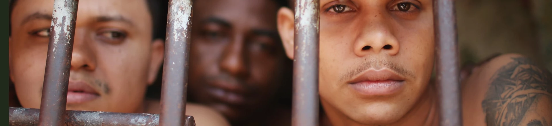 SAO LUIS, BRAZIL - JANUARY 27: Inmates stand in their cell in the Pedrinhas Prison Complex, the largest penitentiary in Maranhao state, on January 27, 2015 in Sao Luis, Brazil. Previously one of the most violent prisons in Brazil, Pedrinhas has seen efforts from a new state administration, new prison officials and judiciary leaders from Maranhao which appear to have quelled some of the unrest within the complex. In 2013, nearly 60 inmates were killed within the complex, including three who were beheaded during rioting. Much of the violence stemmed from broken cells allowing inmates and gang rivals to mix in the patios and open spaces of the complex. Officials recently repaired and repopulated the cells allowing law enforcement access and decreasing violence among prisoners, according to officials. Other reforms include a policy of custody hearings and real-time camera feeds. According to officials there have been no prisoner on prisoner killings inside the complex in nearly four months. Critics believe overcrowding is one of the primary causes of rioting and violence in Brazil's prisons. Additionally, overcrowding has strengthened prison gangs which now span the country and contol certain peripheries of cities including Rio de Janeiro, Sao Paulo and Sao Luis. Brazil now has the fourth-largest prison population in the world behind the U.S., Russia and China. The population of those imprisoned had quadrupled in the past twenty years to around 550,000 and the country needs at least 200,000 new incarceration spaces to eliminate overcrowding. A vast increase in minor drug arrests, a dearth of legal advice for prisoners and a lack of political will for new prisons have contributed to the increases. (Photo by Mario Tama/Getty Images) SAO LUIS, BRAZIL - JANUARY 27: Inmates stand in their cell in the Pedrinhas Prison Complex, the largest penitentiary in Maranhao state, on January 27, 2015 in Sao Luis, Brazil. Previously one of the most violent prisons in Brazil, Pedrinhas has seen efforts from a new state administration, new prison officials and judiciary leaders from Maranhao which appear to have quelled some of the unrest within the complex. In 2013, nearly 60 inmates were killed within the complex, including three who were beheaded during rioting. Much of the violence stemmed from broken cells allowing inmates and gang rivals to mix in the patios and open spaces of the complex. Officials recently repaired and repopulated the cells allowing law enforcement access and decreasing violence among prisoners, according to officials. Other reforms include a policy of custody hearings and real-time camera feeds. According to officials there have been no prisoner on prisoner killings inside the complex in nearly four months. Critics believe overcrowding is one of the primary causes of rioting and violence in Brazil's prisons. Additionally, overcrowding has strengthened prison gangs which now span the country and contol certain peripheries of cities including Rio de Janeiro, Sao Paulo and Sao Luis. Brazil now has the fourth-largest prison population in the world behind the U.S., Russia and China. The population of those imprisoned had quadrupled in the past twenty years to around 550,000 and the country needs at least 200,000 new incarceration spaces to eliminate overcrowding. A vast increase in minor drug arrests, a dearth of legal advice for prisoners and a lack of political will for new prisons have contributed to the increases. (Photo by Mario Tama/Getty Images)