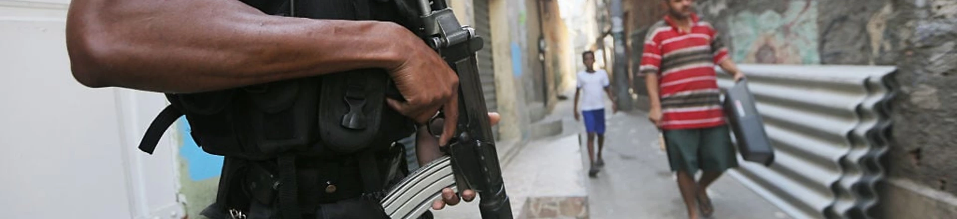 RIO DE JANEIRO, BRAZIL - JULY 26: A UPP (Pacifying Police Unit) officer patrols in the Babilonia favela community, which stands on a hillside above Copacabana beach, an Olympic venue site, on July 26, 2016 in Rio de Janeiro, Brazil. A wave of violence has swept into some of Rio's 'pacified' favelas in recent months in the midst of a hard-hitting economic recession and fights between drug gangs and police. There are ten days to go before the start of the Rio 2016 Olympic Games, (Photo by Mario Tama/Getty Images) RIO DE JANEIRO, BRAZIL - JULY 26: A UPP (Pacifying Police Unit) officer patrols in the Babilonia favela community, which stands on a hillside above Copacabana beach, an Olympic venue site, on July 26, 2016 in Rio de Janeiro, Brazil. A wave of violence has swept into some of Rio's 'pacified' favelas in recent months in the midst of a hard-hitting economic recession and fights between drug gangs and police. There are ten days to go before the start of the Rio 2016 Olympic Games, (Photo by Mario Tama/Getty Images)