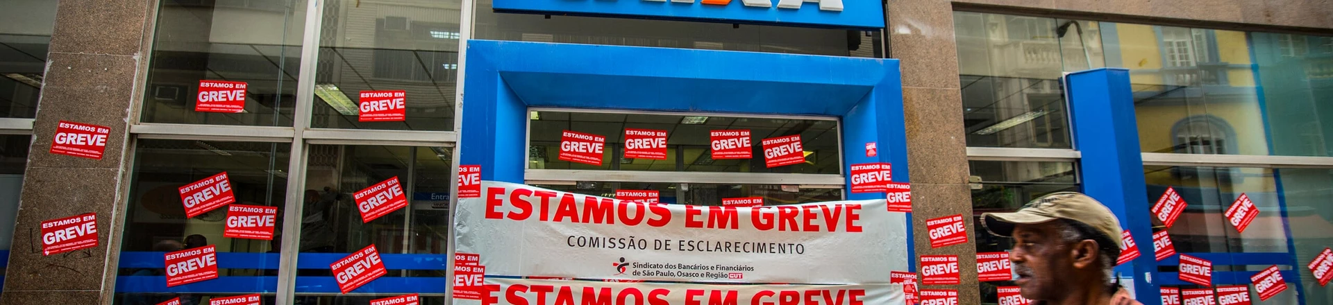 Posters placed in bank branch facade in Sao Paulo, Brazil, informing the strike of the category on September 6, 2016.More than 7,000 agencies stop throughout Brazil, bank went on indefinite strike from September 6.The first day of the strike of bank paralyzed the 7,359 operating branches across the country. The number is equivalent to 31.25% of total branches throughout Brazil, according to Central Bank data (Central Bank).Only in Sao Paulo, the movement ended the first day with a membership of more than 35,000 workers at 680 workplaces. (Photo by Cris Faga/NurPhoto via Getty Images) Posters placed in bank branch facade in Sao Paulo, Brazil, informing the strike of the category on September 6, 2016.More than 7,000 agencies stop throughout Brazil, bank went on indefinite strike from September 6.The first day of the strike of bank paralyzed the 7,359 operating branches across the country. The number is equivalent to 31.25% of total branches throughout Brazil, according to Central Bank data (Central Bank).Only in Sao Paulo, the movement ended the first day with a membership of more than 35,000 workers at 680 workplaces. (Photo by Cris Faga/NurPhoto via Getty Images)