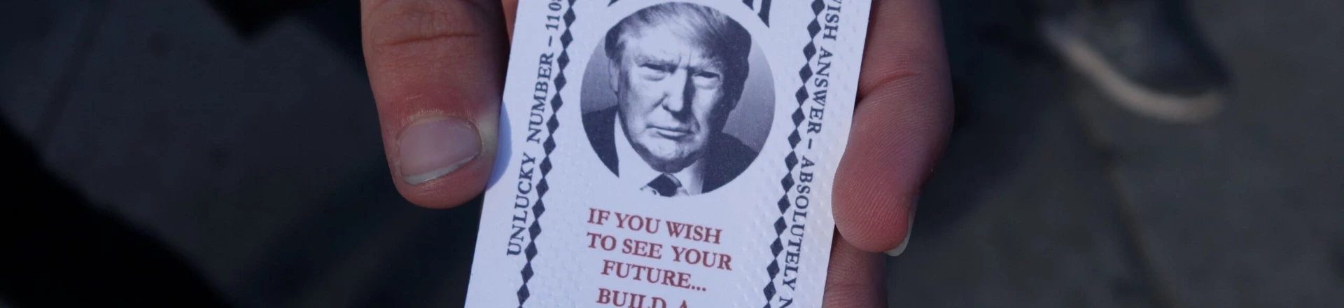 A man hold a card dispensed from the 'All-Seeing Trump', a fortune-telling fairground attraction bearing the likeness of Republican presidential candidate Donald Trump, in New York on October 12, 2016. There's little love for Donald Trump in his hometown these days, so New York has been both tickled and repelled by a fortune-telling, Trump-in-a-box mocking his offense-dishing campaign for president. The Trump-in-a-box has been made to resemble the Zoltar machine made famous in the 1988 Hollywood movie "Big" starring Tom Hanks. / AFP / William EDWARDS (Photo credit should read WILLIAM EDWARDS/AFP/Getty Images) A man hold a card dispensed from the 'All-Seeing Trump', a fortune-telling fairground attraction bearing the likeness of Republican presidential candidate Donald Trump, in New York on October 12, 2016. There's little love for Donald Trump in his hometown these days, so New York has been both tickled and repelled by a fortune-telling, Trump-in-a-box mocking his offense-dishing campaign for president. The Trump-in-a-box has been made to resemble the Zoltar machine made famous in the 1988 Hollywood movie "Big" starring Tom Hanks. / AFP / William EDWARDS (Photo credit should read WILLIAM EDWARDS/AFP/Getty Images)