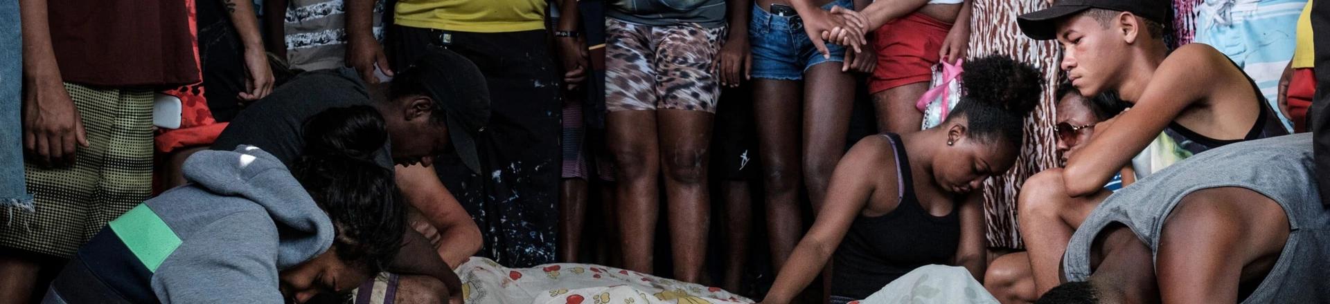 Family members mourn victims from a police operation against drug dealers that occurred on November 19 at Cidade de Deus favela (community) in Rio de Janeiro, Brazil, on November 20, 2016.Rio, which is home to 6.5 million people and drastic social inequality, suffers from high levels of criminality, made worse by heavily armed gangs of narcotraffickers, but also by the presence of paramilitary militias. / AFP / YASUYOSHI CHIBA (Photo credit should read YASUYOSHI CHIBA/AFP/Getty Images) Family members mourn victims from a police operation against drug dealers that occurred on November 19 at Cidade de Deus favela (community) in Rio de Janeiro, Brazil, on November 20, 2016.Rio, which is home to 6.5 million people and drastic social inequality, suffers from high levels of criminality, made worse by heavily armed gangs of narcotraffickers, but also by the presence of paramilitary militias. / AFP / YASUYOSHI CHIBA (Photo credit should read YASUYOSHI CHIBA/AFP/Getty Images)