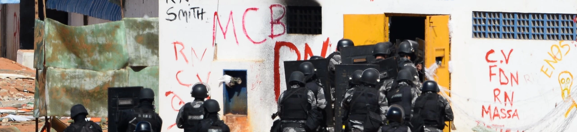 Members of the special police battalion enter the Alcacuz Penitentiary Center to regain control of the penitentiary in Rio Grande do Norte, Brazil, on January 18, 2017.Brazilian authorities said Wednesday they are deploying 1,000 troops to "clean out" arms and cellphones from restive prisons while police struggled to end a deadly gang face-off at Alcacuz. The soldiers were being brought in to respond to a "national emergency" in the badly overcrowded prison system, Defence Minister Raul Jungmann said. / AFP / ANDRESSA ANHOLETE (Photo credit should read ANDRESSA ANHOLETE/AFP/Getty Images) Members of the special police battalion enter the Alcacuz Penitentiary Center to regain control of the penitentiary in Rio Grande do Norte, Brazil, on January 18, 2017.Brazilian authorities said Wednesday they are deploying 1,000 troops to "clean out" arms and cellphones from restive prisons while police struggled to end a deadly gang face-off at Alcacuz. The soldiers were being brought in to respond to a "national emergency" in the badly overcrowded prison system, Defence Minister Raul Jungmann said. / AFP / ANDRESSA ANHOLETE (Photo credit should read ANDRESSA ANHOLETE/AFP/Getty Images)