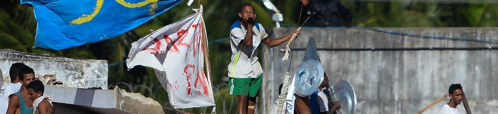 Armed and defiant inmates gather on the roofs of the Alcacuz Penitentiary, near Natal, on January 19, 2017.Stick-wielding inmates hurled stones and lit fires Thursday in the jail where dozens were previously massacred, as authorities struggled to contain a spreading wave of gang violence. The governor of the surrounding Rio Grande do Norte state, Robinson Faria, called for the armed forces to deploy in the streets of Natal after rioting spread beyond the prison. / AFP / ANDRESSA ANHOLETE (Photo credit should read ANDRESSA ANHOLETE/AFP/Getty Images) Armed and defiant inmates gather on the roofs of the Alcacuz Penitentiary, near Natal, on January 19, 2017.Stick-wielding inmates hurled stones and lit fires Thursday in the jail where dozens were previously massacred, as authorities struggled to contain a spreading wave of gang violence. The governor of the surrounding Rio Grande do Norte state, Robinson Faria, called for the armed forces to deploy in the streets of Natal after rioting spread beyond the prison. / AFP / ANDRESSA ANHOLETE (Photo credit should read ANDRESSA ANHOLETE/AFP/Getty Images)
