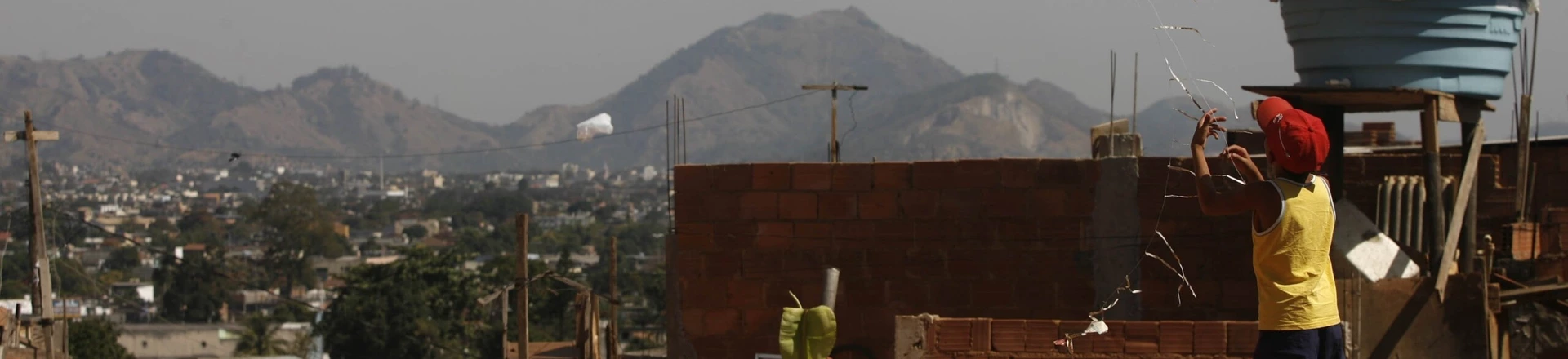 Criança brinca com pipa em rua da favela Jardim Batam, no Realengo, zona oeste do Rio de Janeiro. Criança brinca com pipa em rua da favela Jardim Batam, no Realengo, zona oeste do Rio de Janeiro.