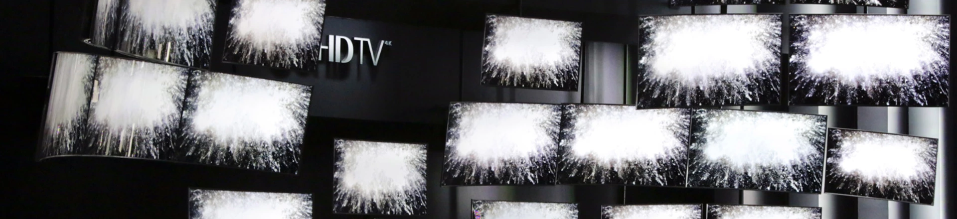 FILE - In this Thursday, Jan. 8, 2015, file photo, attendees watch a presentation at the Samsung booth at the International CES, in Las Vegas. For years, TV makers have focused on making pictures sharper by squeezing more pixels onto screens, but now their attention is shifting to improving the way sets display color, with a newish technology called HDR taking center stage. (AP Photo/Jae C. Hong, File) FILE - In this Thursday, Jan. 8, 2015, file photo, attendees watch a presentation at the Samsung booth at the International CES, in Las Vegas. For years, TV makers have focused on making pictures sharper by squeezing more pixels onto screens, but now their attention is shifting to improving the way sets display color, with a newish technology called HDR taking center stage. (AP Photo/Jae C. Hong, File)