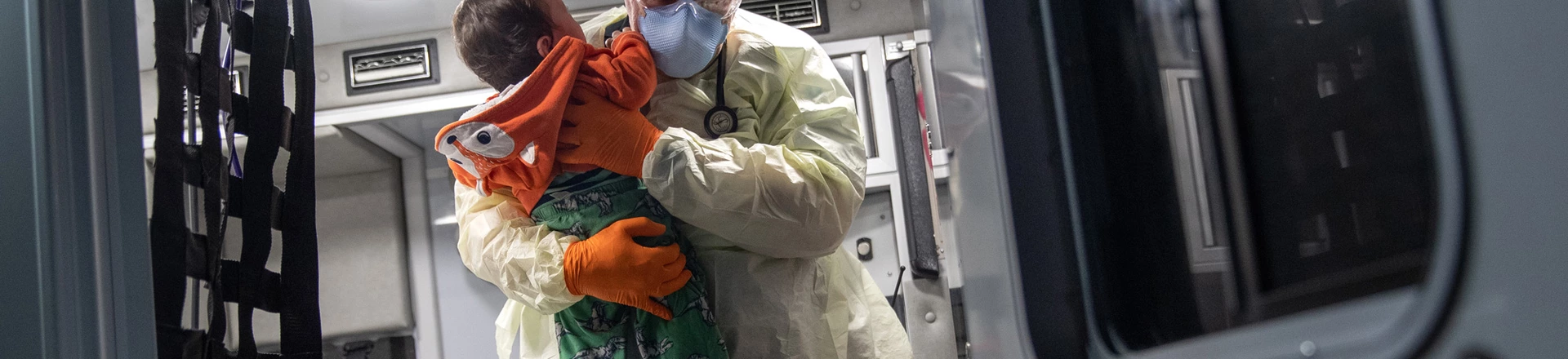 Paramédico segura bebê com febre após chegar de ambulância no hospital de Stamford, em 4 de abril. Paramédico segura bebê com febre após chegar de ambulância no hospital de Stamford, em 4 de abril.