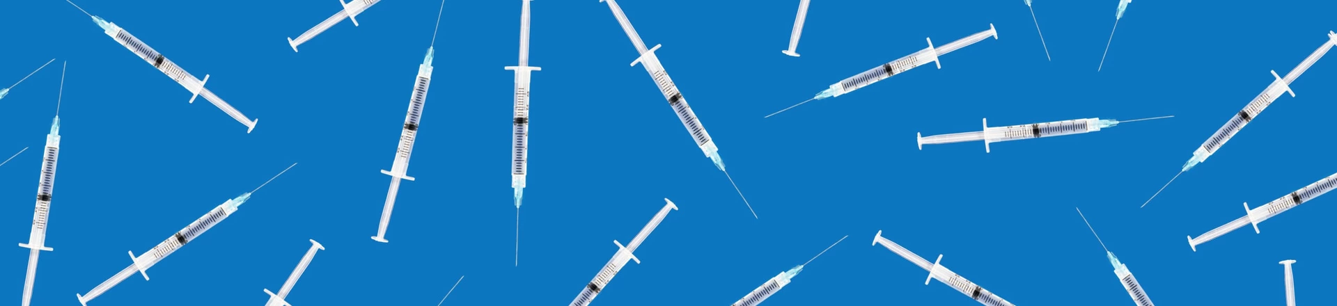 Many medical syringes scattered on blue background Many medical syringes scattered on blue background