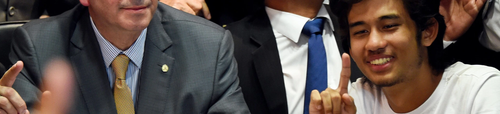 Kim Kataguiri (R), leader of the Free Brazil Movement (MBL), meets with Brazilian Lower House President Eduardo Cunha in Brasilia, Brazil on May 27, 2015. Kataguiri, a 19-year-old college drop out, is the face of MBL, a growing force which seeks to harness some of the energy of the 2013 protest movement which brought more than a million onto the streets. AFP PHOTO/EVARISTO SA (Photo credit should read EVARISTO SA/AFP/Getty Images) Kim Kataguiri (R), leader of the Free Brazil Movement (MBL), meets with Brazilian Lower House President Eduardo Cunha in Brasilia, Brazil on May 27, 2015. Kataguiri, a 19-year-old college drop out, is the face of MBL, a growing force which seeks to harness some of the energy of the 2013 protest movement which brought more than a million onto the streets. AFP PHOTO/EVARISTO SA (Photo credit should read EVARISTO SA/AFP/Getty Images)