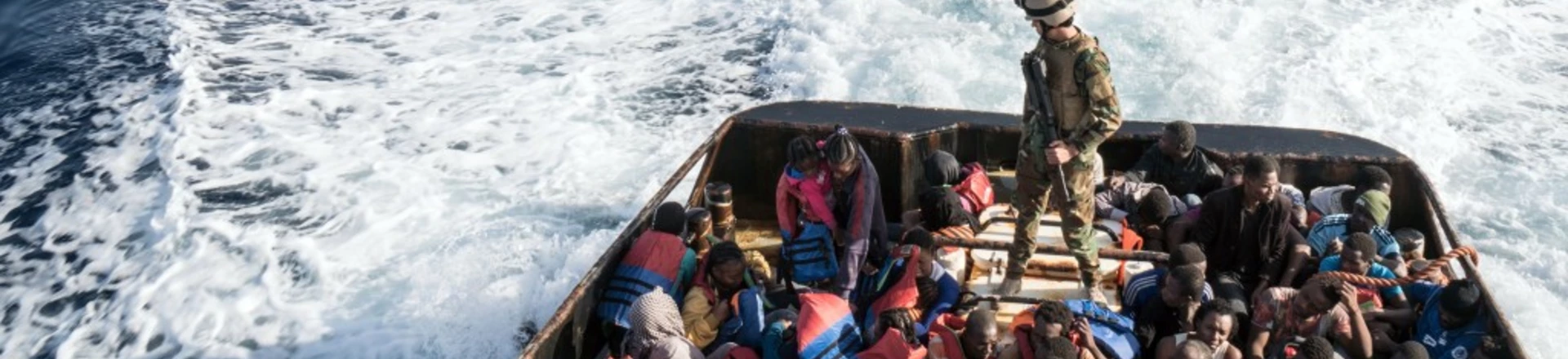 A Libyan coast guardsman stands on a boat during the rescue of 147 illegal immigrants attempting to reach Europe off the coastal town of Zawiyah, 45 kilometres west of the capital Tripoli, on June 27, 2017.More than 8,000 migrants have been rescued in waters off Libya during the past 48 hours in difficult weather conditions, Italy's coastguard said on June 27, 2017. / AFP PHOTO / Taha JAWASHI (Photo credit should read TAHA JAWASHI/AFP/Getty Images) A Libyan coast guardsman stands on a boat during the rescue of 147 illegal immigrants attempting to reach Europe off the coastal town of Zawiyah, 45 kilometres west of the capital Tripoli, on June 27, 2017.More than 8,000 migrants have been rescued in waters off Libya during the past 48 hours in difficult weather conditions, Italy's coastguard said on June 27, 2017. / AFP PHOTO / Taha JAWASHI (Photo credit should read TAHA JAWASHI/AFP/Getty Images)