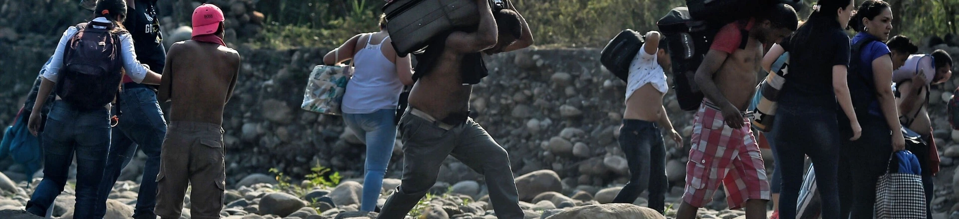 People taking irregular roads cross the Tachira river from Cucuta in Colombia to San Antonio del Tachira in Venezuela, near the Simon Bolivar international Bridge, on February 25, 2019. - United States Vice President Mike Pence told Venezuelan opposition leader Juan Guaido that Donald Trump supports him "100 percent" as the pair met regional allies on Monday to thrash out a strategy to remove Nicolas Maduro from power after the failed attempt to ship in humanitarian aid. (Photo by Luis ROBAYO / AFP) (Photo credit should read LUIS ROBAYO/AFP/Getty Images) People taking irregular roads cross the Tachira river from Cucuta in Colombia to San Antonio del Tachira in Venezuela, near the Simon Bolivar international Bridge, on February 25, 2019. - United States Vice President Mike Pence told Venezuelan opposition leader Juan Guaido that Donald Trump supports him "100 percent" as the pair met regional allies on Monday to thrash out a strategy to remove Nicolas Maduro from power after the failed attempt to ship in humanitarian aid. (Photo by Luis ROBAYO / AFP) (Photo credit should read LUIS ROBAYO/AFP/Getty Images)