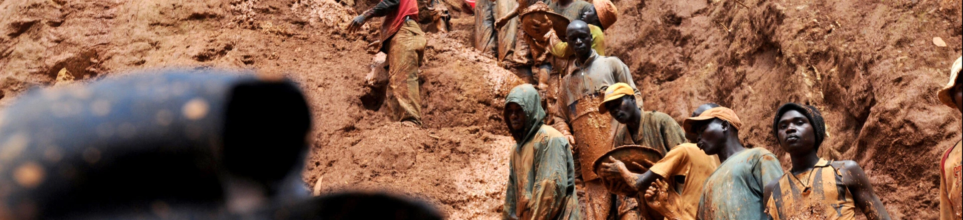 (FILES) This photo taken February 23, 2009 shows mining workers standing on a muddy cliff as they work at a gold mine in Chudja, near Bunia, north eastern Congo. Eighteen prospectors were killed overnight on August 19-20, 2009 in a diamond mine in central Democratic Republic of Congo, union officials said on August 20, 2009. Celestin Kubela, the head of the local mining authority in Kasai province, said that the victims, who were all illlegal miners, are thought to have touched a power cable deep underground. AFP PHOTO / LIONEL HEALING (Photo credit should read LIONEL HEALING/AFP/Getty Images) (FILES) This photo taken February 23, 2009 shows mining workers standing on a muddy cliff as they work at a gold mine in Chudja, near Bunia, north eastern Congo. Eighteen prospectors were killed overnight on August 19-20, 2009 in a diamond mine in central Democratic Republic of Congo, union officials said on August 20, 2009. Celestin Kubela, the head of the local mining authority in Kasai province, said that the victims, who were all illlegal miners, are thought to have touched a power cable deep underground. AFP PHOTO / LIONEL HEALING (Photo credit should read LIONEL HEALING/AFP/Getty Images)