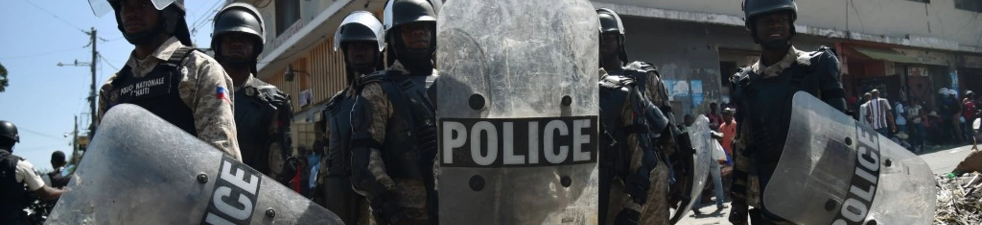 Police watch as demonstrators march to protest against the government of Haitian President Jovenel Moise in Port-au-Prince October 24, 2017. / AFP PHOTO / HECTOR RETAMAL (Photo credit should read HECTOR RETAMAL/AFP/Getty Images) Police watch as demonstrators march to protest against the government of Haitian President Jovenel Moise in Port-au-Prince October 24, 2017. / AFP PHOTO / HECTOR RETAMAL (Photo credit should read HECTOR RETAMAL/AFP/Getty Images)